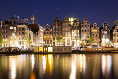 Reflection of buildings in city at night