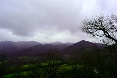 Scenic view of mountains against cloudy sky