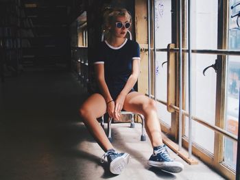 Young woman sitting in sunglasses