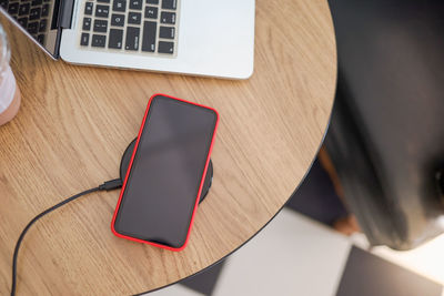 High angle view of mobile phone on table