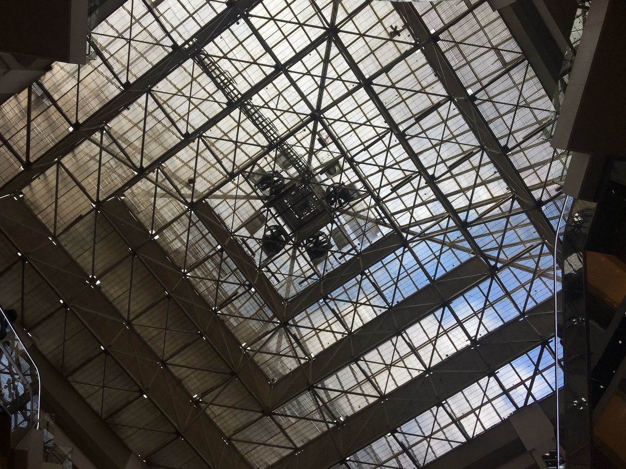 LOW ANGLE VIEW OF SKYLIGHT IN GLASS BUILDING