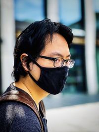 Portrait of young man in eyeglasses and face mask 