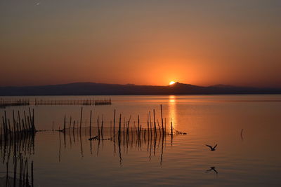 Scenic view of lake against sky during sunset