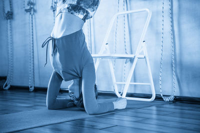 Low section of woman standing on hardwood floor