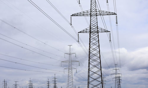 Low angle view of electricity pylon against sky