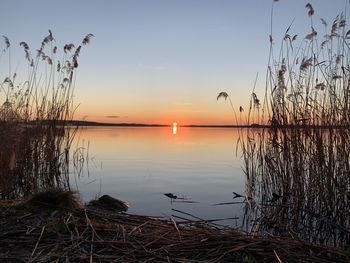 Scenic view of lake against sky during sunset