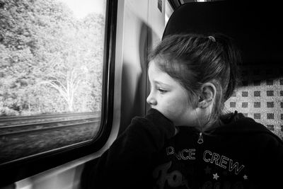 Girl looking through train window