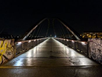 Illuminated suspension bridge at night