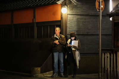 Woman using mobile phone in city