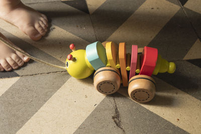 Low section of person with toys on floor