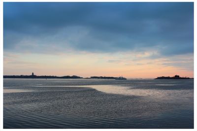 Scenic view of calm sea at sunset