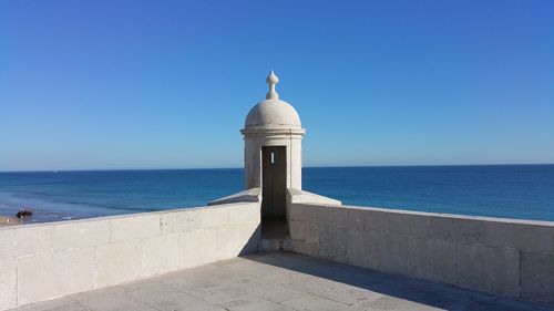 View of sea against clear blue sky