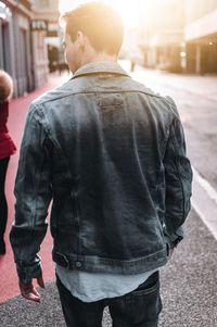 Rear view of man walking on street