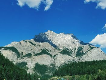 Scenic view of mountains against blue sky