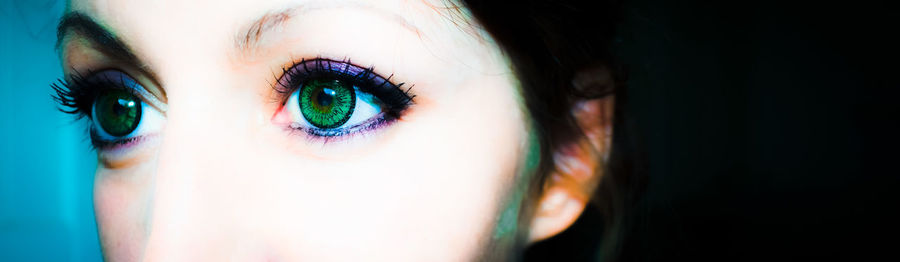 Close-up portrait of woman with green eyes