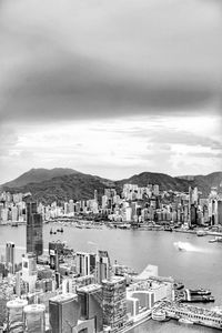 High angle view of city by sea against sky