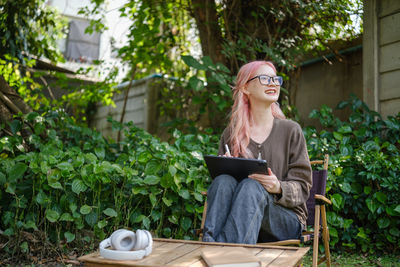 Portrait of young woman using mobile phone