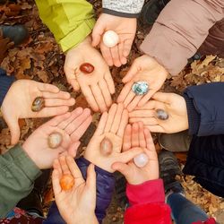 High angle view of hands holding stones