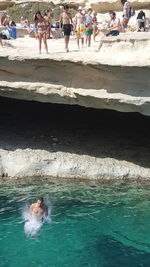 People swimming in sea