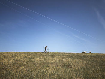 Scenic view of land against blue sky