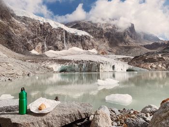 Scenic view of lake and mountains against sky