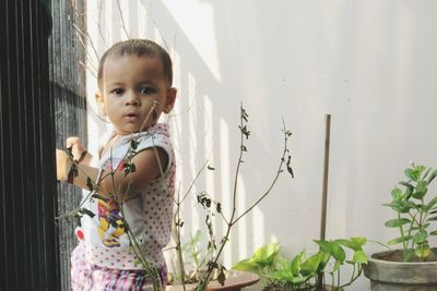 Portrait of cute baby girl standing at home