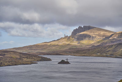 Scenic view of sea and mountains against sky