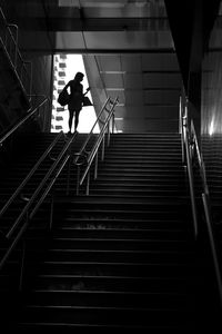 Low angle view of woman standing on steps in subway