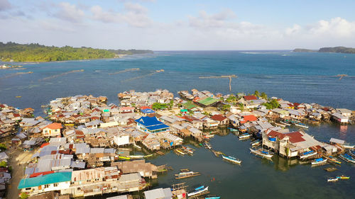 Village of fishermen with houses on the water, with fishing boats. philippines, mindanao.