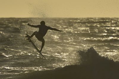 People on beach at sunset