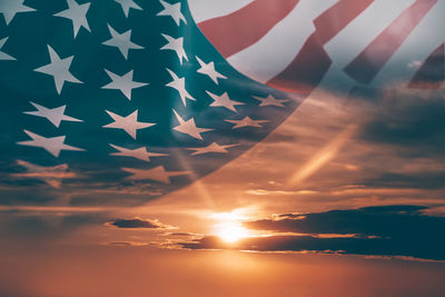 Low angle view of flag against sky during sunset