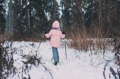 Full length of woman standing on snow covered land