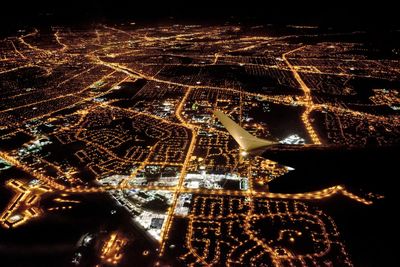 Aerial view of illuminated buildings in city at night