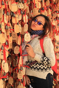 Portrait of smiling woman standing by prayer blocks