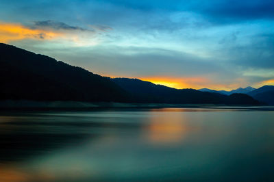 Scenic view of lake at sunset