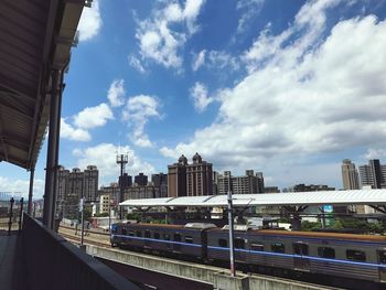 Train in city against sky