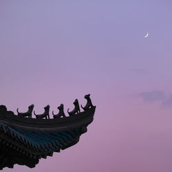 Low angle view of silhouette temple against sky during sunset