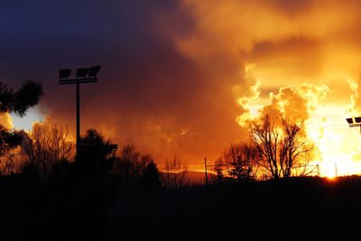 Low angle view of basketball hoop against sky during sunset