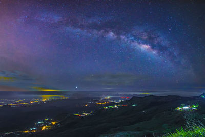 Aerial view of illuminated star field against sky at night