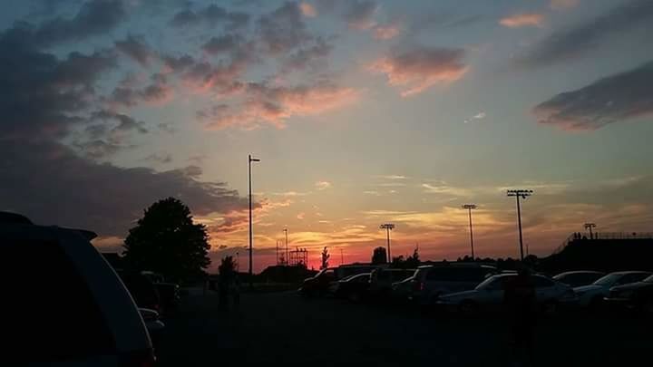 SILHOUETTE CARS ON ROAD AGAINST SKY DURING SUNSET