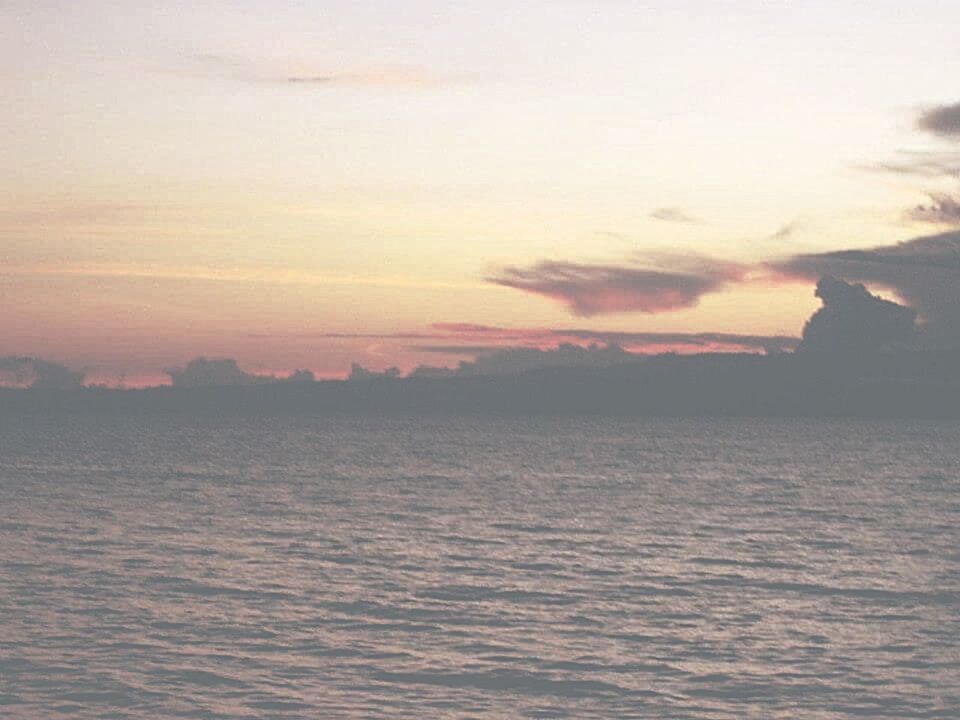 SCENIC VIEW OF CALM SEA AT SUNSET