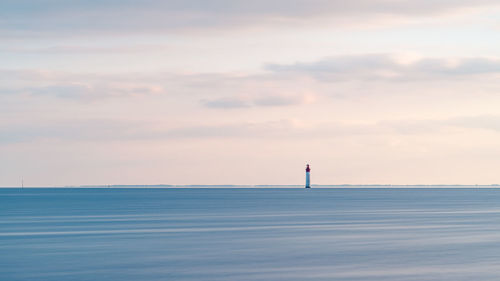 Beautiful minimalist seascape at sunset with chauveau lighthouse. rivedoux, re island, france