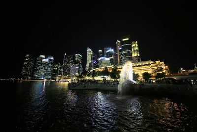 Illuminated city at waterfront