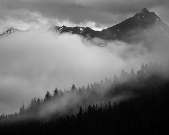 Scenic view of mountains against sky during foggy weather