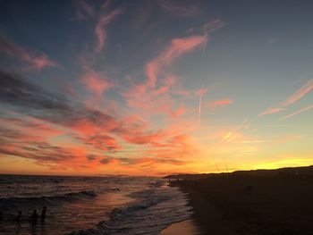 Scenic view of beach against sky during sunset