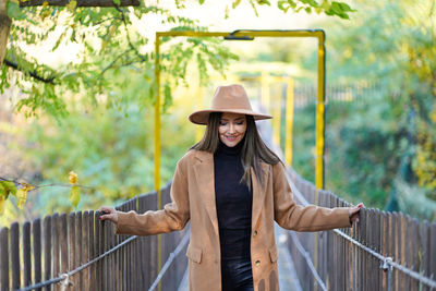 Young woman standing on footbridge