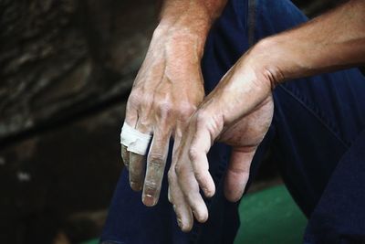 Midsection of man hands with bandage