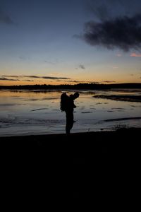 Silhouette of people standing on beach