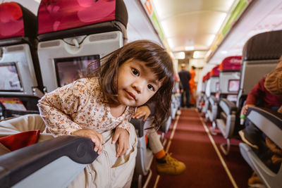 Portrait of young woman sitting in bus