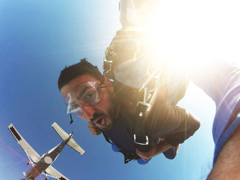 Portrait of young man against sky